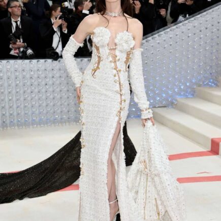 Anne Hathaway Attends the Met Gala 2023 in a White Tweed Versace Gown