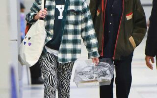 Emma Watson Arrives with a Friend at JFK Airport in a Casual Outfit
