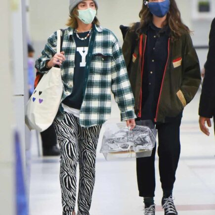 Emma Watson Arrives with a Friend at JFK Airport in a Casual Outfit