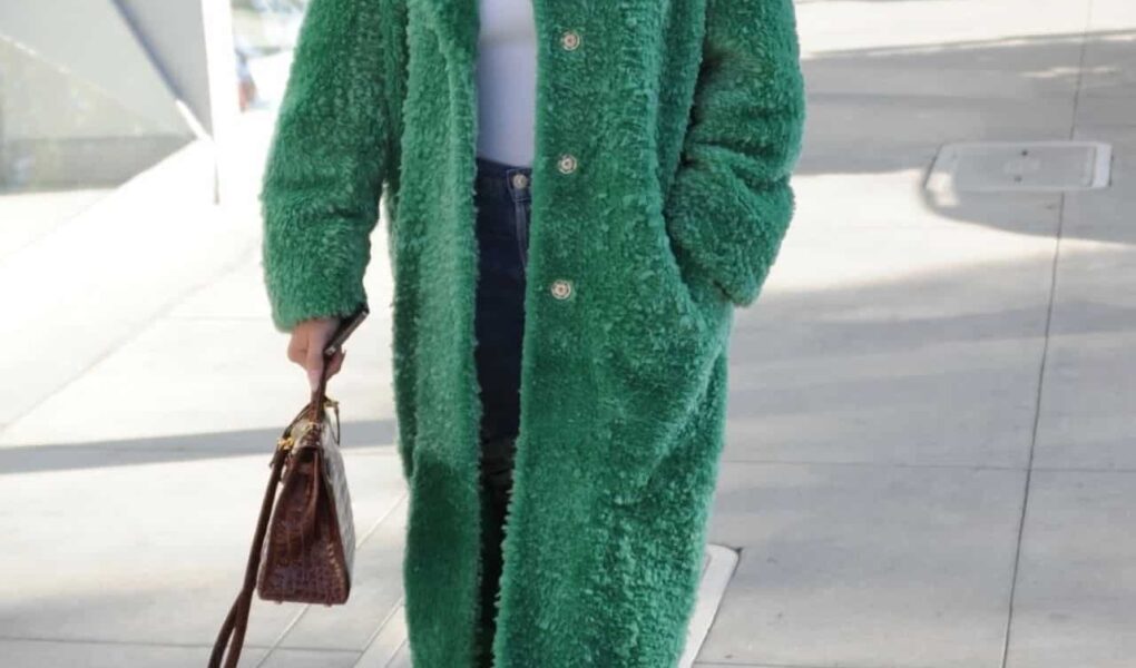 Chrissy Teigen Arrives in Style Wearing a Long Green Coat at Il Pastaio