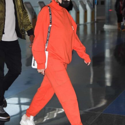 Selena Gomez Arrives at JFK Airport in an All-Orange Casual Outfit