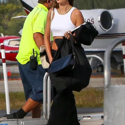 Hailey Bieber in a Crop Top and Sweats Steps Off a Private Plane in Miami