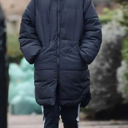 The Crown’s Star Emma Corrin Looks Very Casual in Long Jacket and Knit Cap