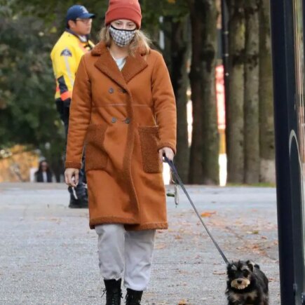 Lili Reinhart in the Brown Fleece-lined Coat Takes her Dog for a Walk in Vancouver