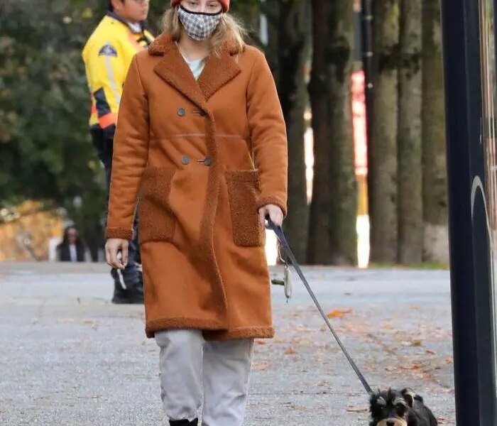 Lili Reinhart in the Brown Fleece-lined Coat Takes her Dog for a Walk in Vancouver