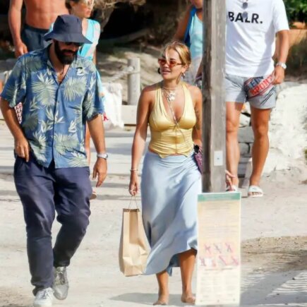 Rita Ora Opts for a Gold Crop Top as She Walks with BF in Ibiza