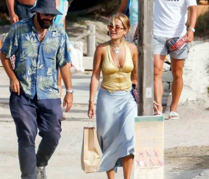 Rita Ora Opts for a Gold Crop Top as She Walks with BF in Ibiza