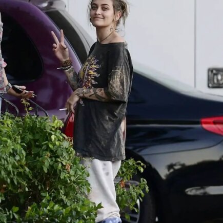 Paris Jackson in a Peace Sign T-shirt as she Smokes with Friends