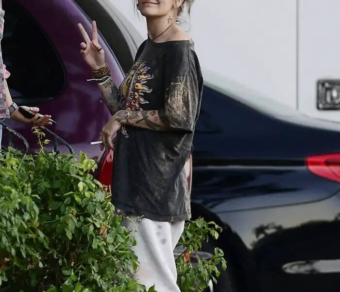 Paris Jackson in a Peace Sign T-shirt as she Smokes with Friends