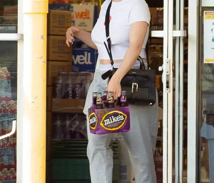 Ariel Winter in a Rolling Stones T-shirt Stocks Up Alcohol