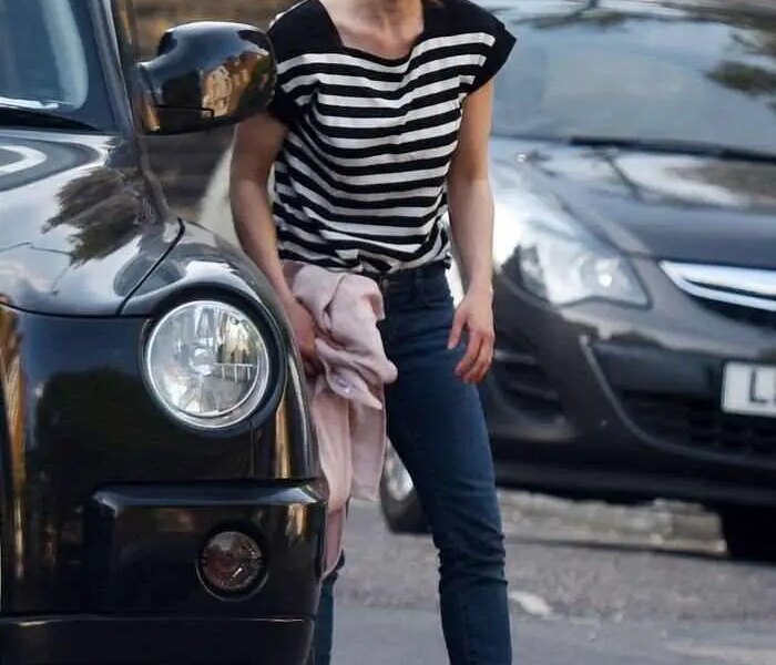 Emilia Clarke Cuts a Casual Figure in Black and White Striped T-Shirt