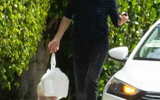 Charlize Theron Outside Her Home Grabbing a Food Delivery