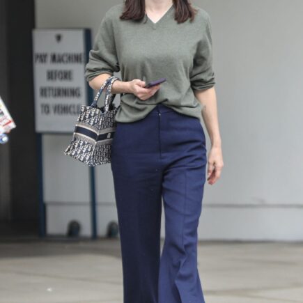 Alexandra Daddario Exudes Casual Chic in Olive Sweater and Navy Pants