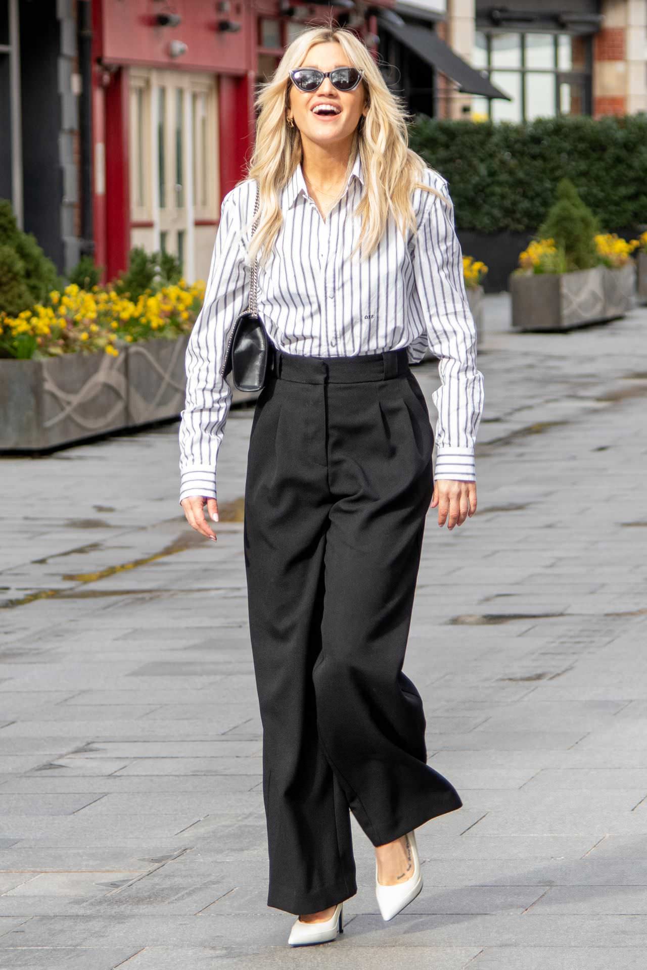 ashley roberts is chic in a striped blouse and black pants 1