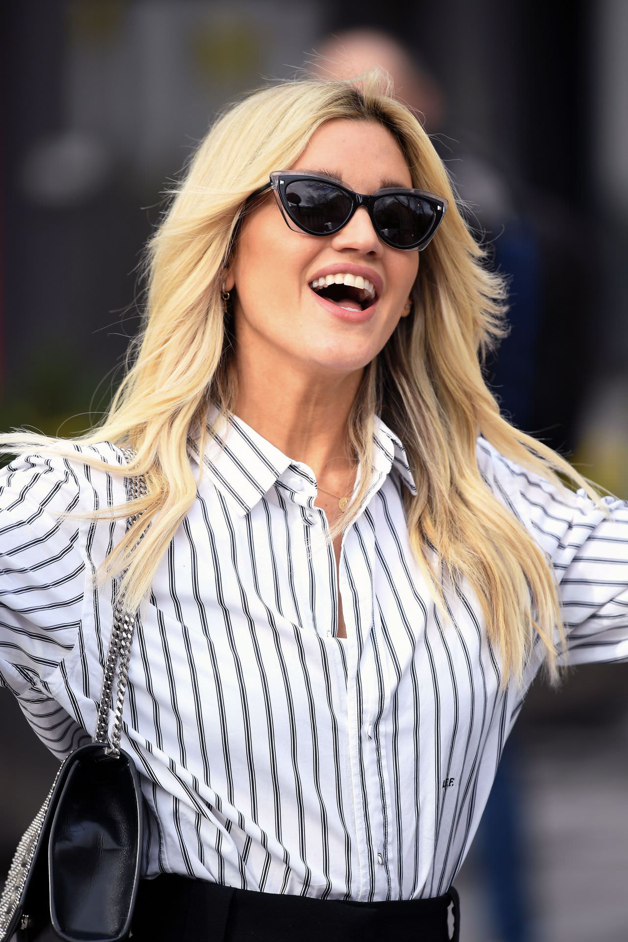 ashley roberts is chic in a striped blouse and black pants 3