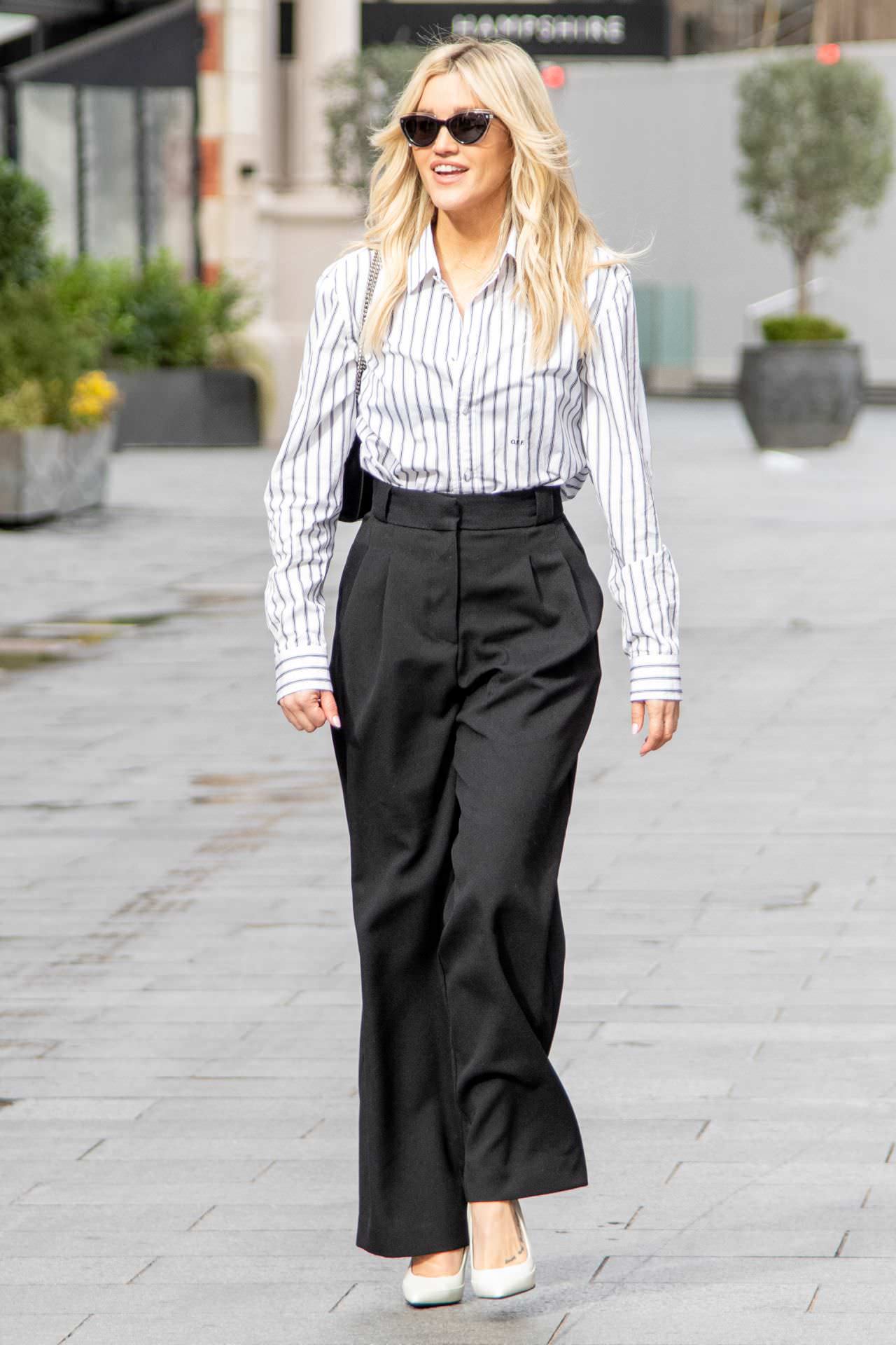 ashley roberts is chic in a striped blouse and black pants 5