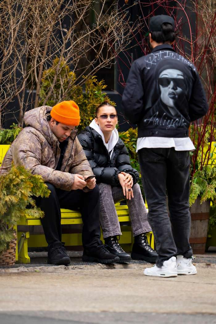 bella hadid in casual outfit on a park bench in new york city with a friend 2