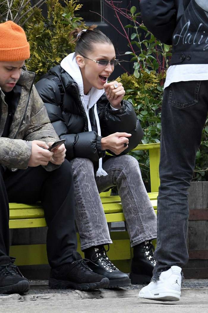 bella hadid in casual outfit on a park bench in new york city with a friend 3