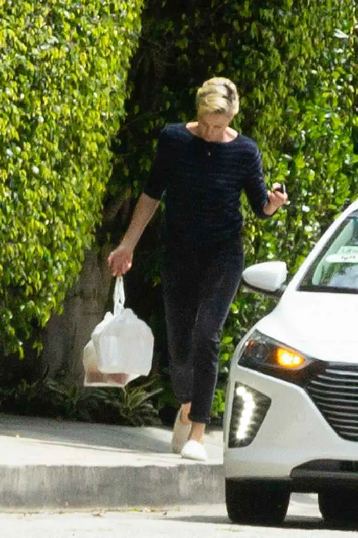 charlize theron outside her home grabbing a food delivery 2