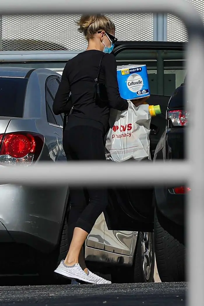 charlotte mckinney in a black outfit during a masked pharmacy run 4