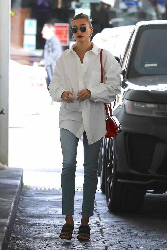 hailey rhode bieber in balenciaga white shirt khaite kyle blue jeans visiting a skincare clinic 1