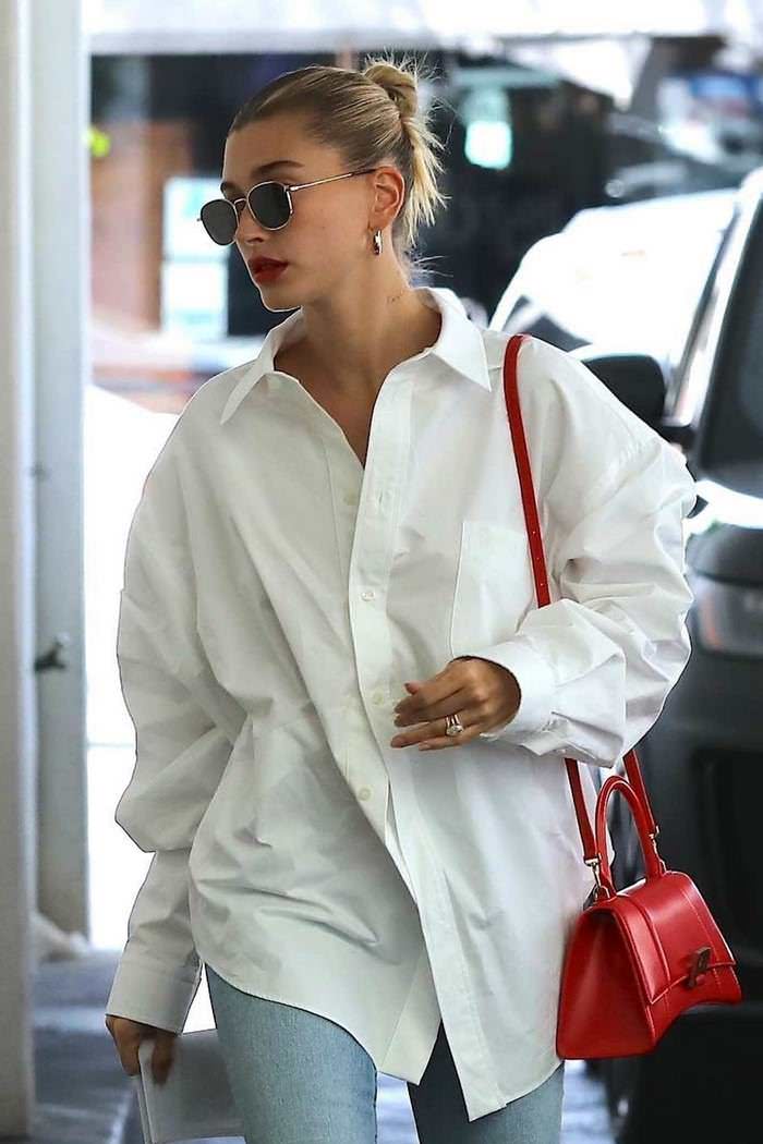 hailey rhode bieber in balenciaga white shirt khaite kyle blue jeans visiting a skincare clinic 2