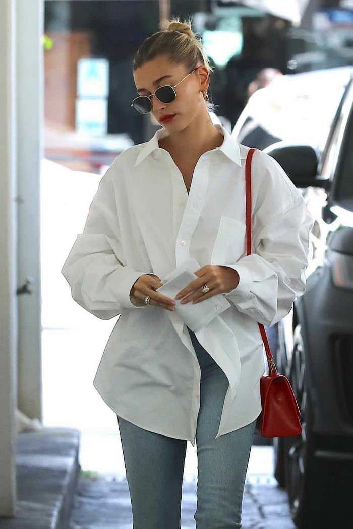 hailey rhode bieber in balenciaga white shirt khaite kyle blue jeans visiting a skincare clinic 4