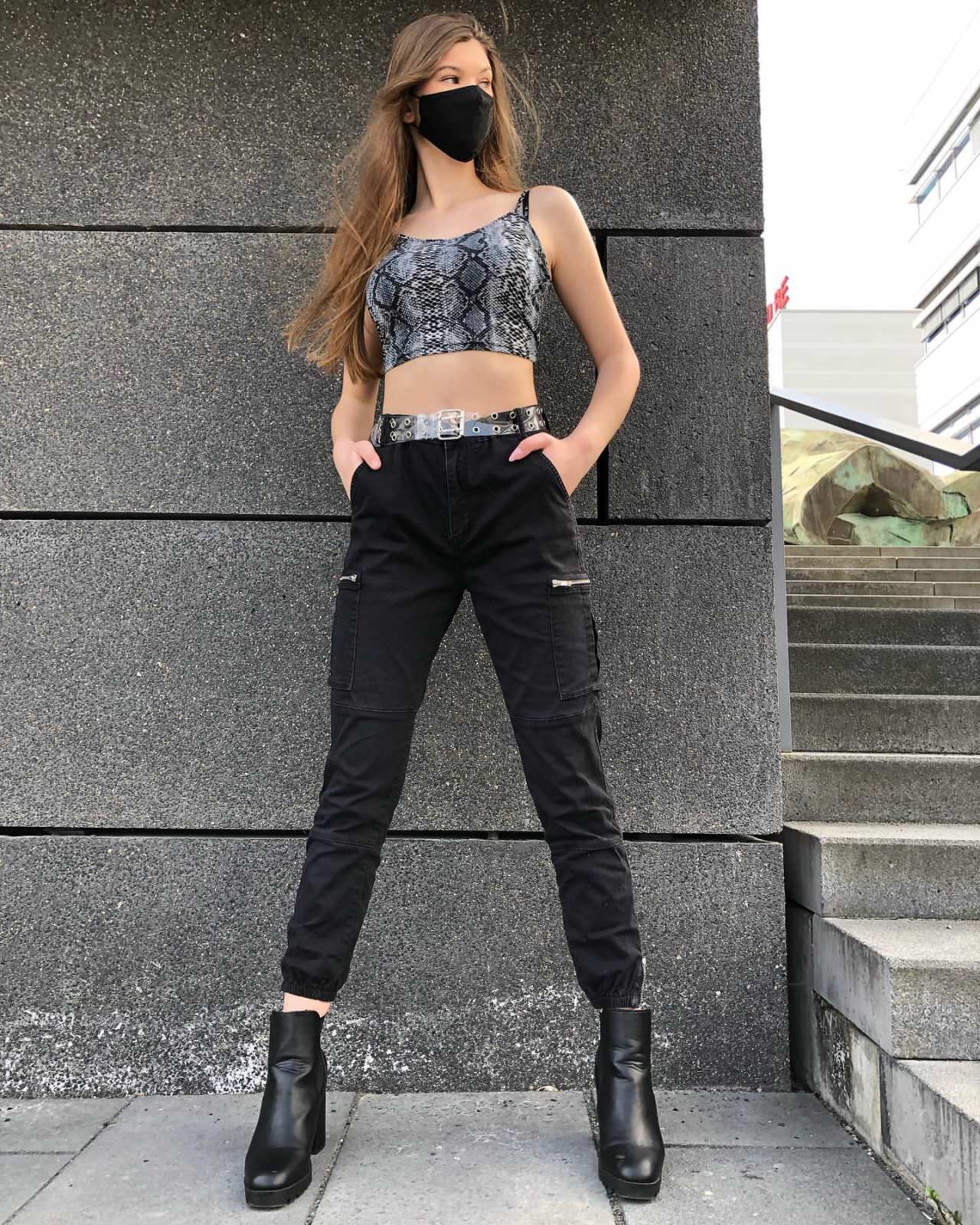 laura offermann posing in crop top and black pants 3