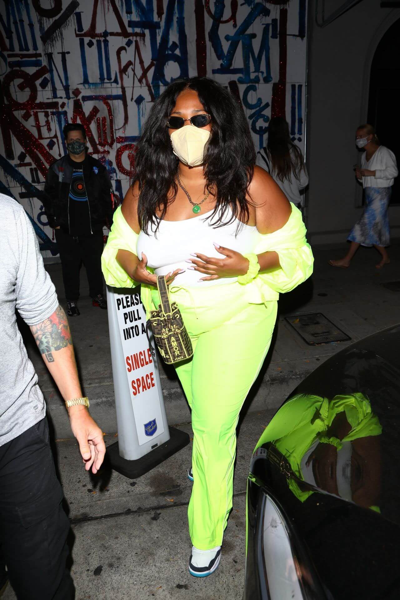 lizzo in neon green outfit at craig s in west hollywood 2
