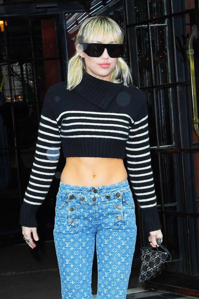 miley cyrus in a cut off sweater leaving her hotel in new york 1