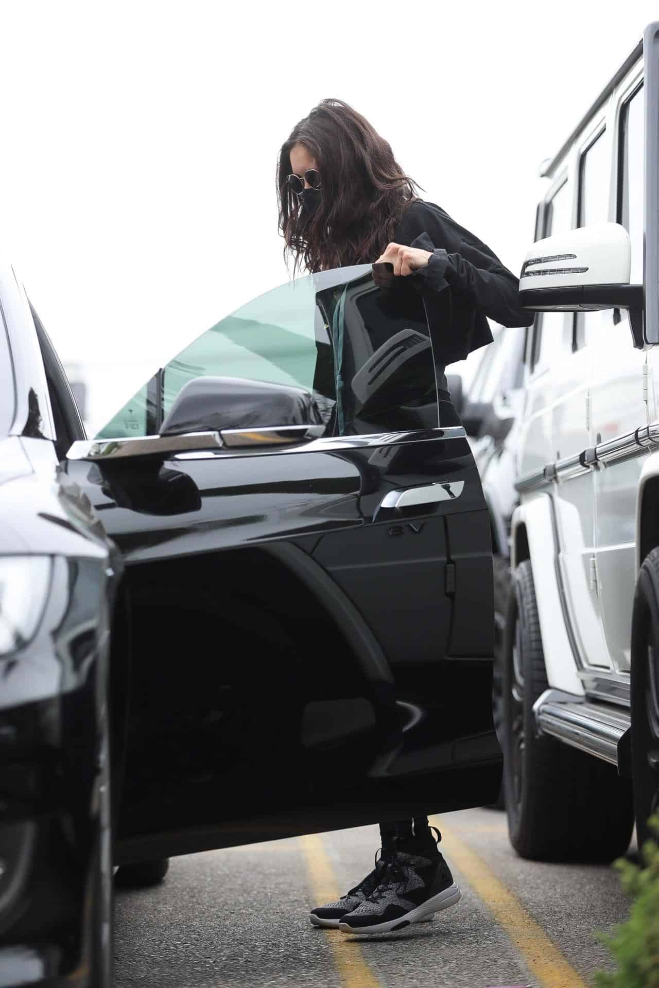 nina dobrev showcases her svelte figure in a black outfit 1