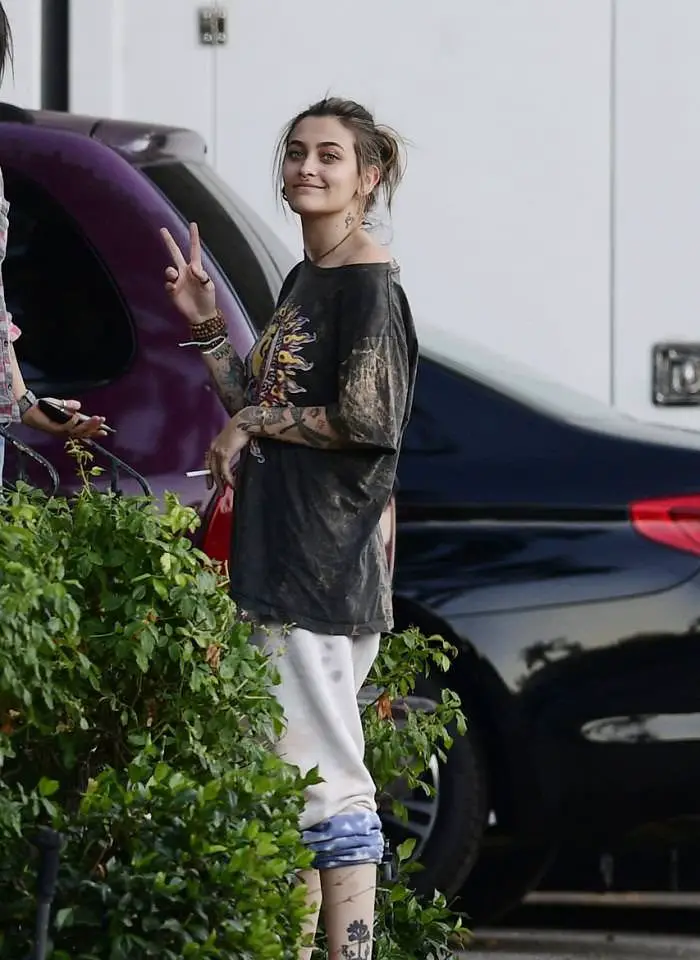 paris jackson in a peace sign t shirt as she smokes with friends 3