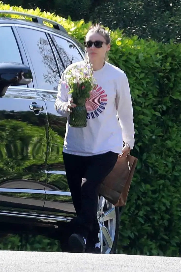 rooney mara carries flowers to older sister for her first mother s day 2